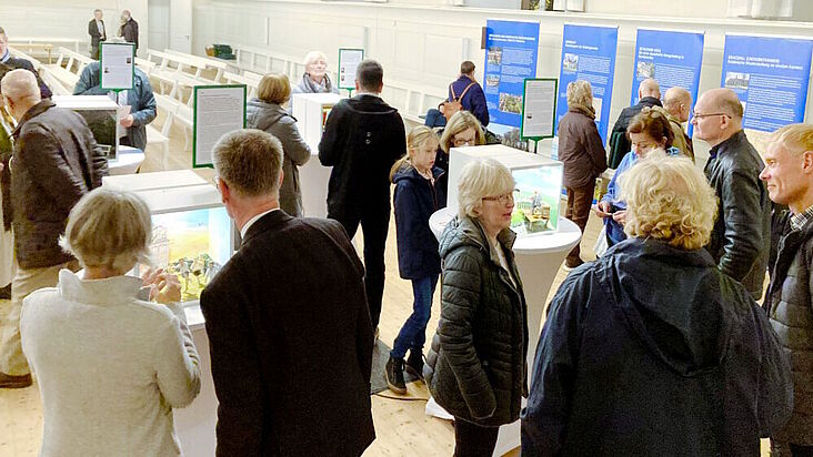 Menschen, die sich die Ausstellung im Neuwieder Kirchensaal anschauen